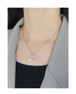 Close-up of S925 silver necklace with shell flower and pink zircon pendant on model