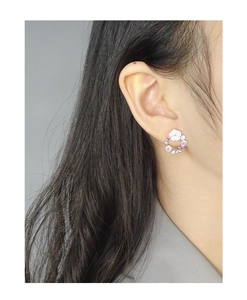 Close-up of S925 silver flower stud earring with colorful zircons and shell petals on model