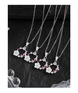 Detailed close-up of S925 silver necklaces with shell flowers and colorful zircons