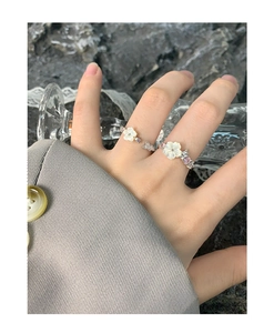 Close-up of S925 silver open ring featuring a shell flower and crystal butterfly design