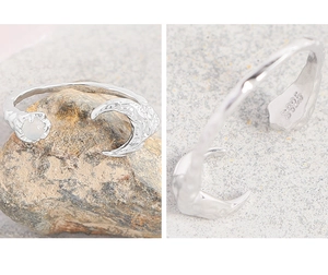 Macro detail of S925 sterling silver ring showing moon texture and hallmark