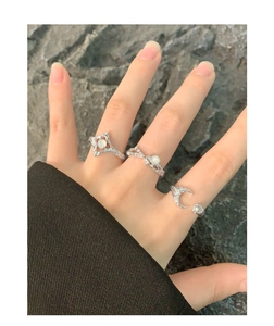 Detail of three S925 silver rings with molten lava texture and translucent moonstones