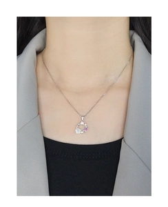 Detail of S925 silver necklace with shell flower pendant and colorful zircon stones