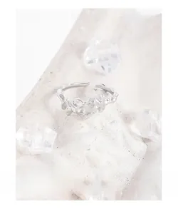 Macro detail of S925 silver ring featuring liquid metal lava texture and heart shape