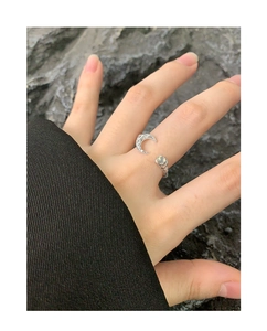 Macro shot of S925 sterling silver ring featuring a moon motif and glowing agate stone