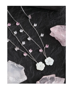 Detail of S925 silver necklace with shell flower pendant and pink zircon stones