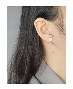 Detail of S925 silver earring featuring shell flower, long chain, and drop pendant