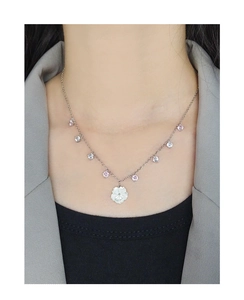 Detail of S925 silver necklace featuring a shell flower pendant and pink zircon accents