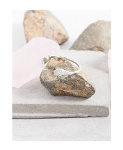 Detailed macro of S925 silver moonstone ring with embossed texture on natural stone