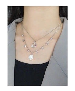 Detail of S925 silver double-layered necklace featuring shell flowers and zircon stones