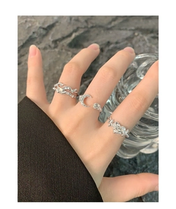 Close-up of S925 silver rings set with irregular heart and moon agate details
