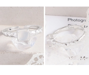 Detail of S925 sterling silver ring featuring a square gemstone and hammered texture