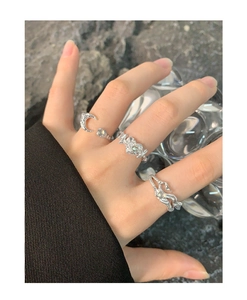 Close-up of S925 silver rings with organic textures and moonstone on hand