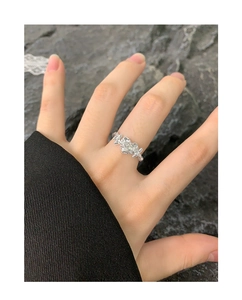 Macro detail of S925 silver irregular heart ring with clear zircon on a finger