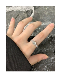 Detail of S925 silver ring featuring a square agate stone and twisted rope band texture