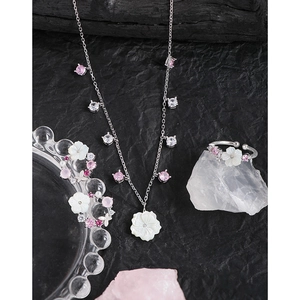 S925 sterling silver shell flower necklace and ring set with zircons on dark background