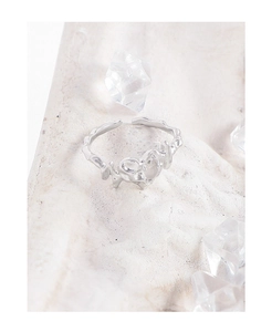 Macro shot of silver S925 irregular heart ring with white agate on stone base