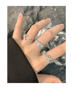 Close-up of S925 silver rings with irregular heart and moon shapes on model hand