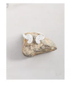 Macro detail of S925 sterling silver ring with wrinkled texture on natural stone