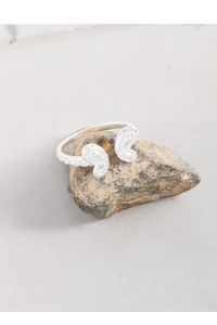 Macro detail of S925 sterling silver ring showing textured hammered finish and open design