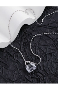 Detailed view of S925 silver necklace with minimalist clear crystal bag pendant
