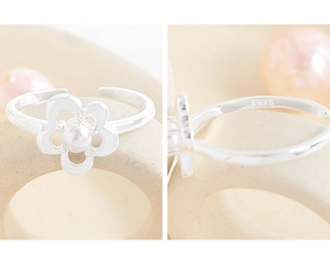 Macro detail of S925 sterling silver ring showing floral design and hallmark stamp