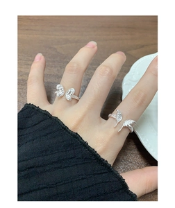 Close-up of S925 sterling silver butterfly rings with textured finish on hands