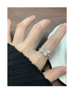Detail of S925 silver butterfly ring with textured wings and adjustable band