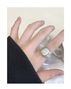 Detailed view of S925 sterling silver ring with oval white shell inlay and textured band