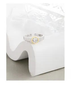 Macro detail of S925 sterling silver ring with gear texture and gold-rimmed zircon stone