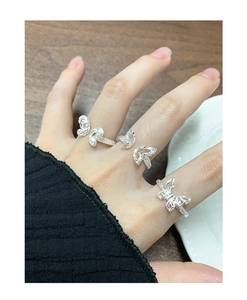 Detailed close-up of three S925 silver butterfly rings with textured crushed metal finish