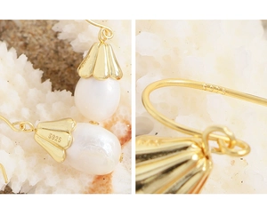 Macro detail of S925 sterling silver stamp on elegant bellflower pearl earrings