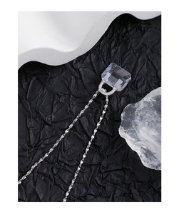 Macro shot of S925 sterling silver twist chain with a clear crystal handbag pendant