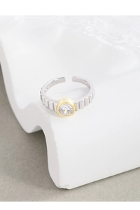Macro detail of S925 sterling silver ring featuring a zircon stone and gear texture