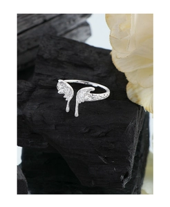 Macro shot of silver S925 butterfly ring featuring irregular molten texture on black charcoal