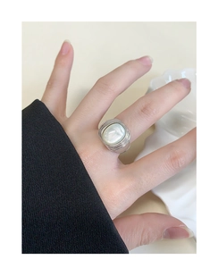 Close-up of S925 silver ring with white mother-of-pearl oval inlay on a finger