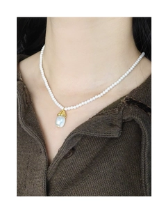 Close-up of S925 silver necklace featuring round pearls and a baroque pearl drop pendant