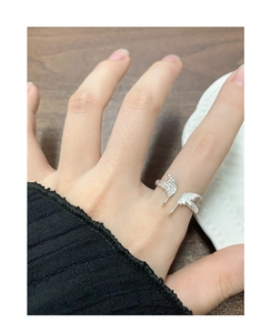 Close-up of S925 sterling silver butterfly ring with pleated texture and adjustable band