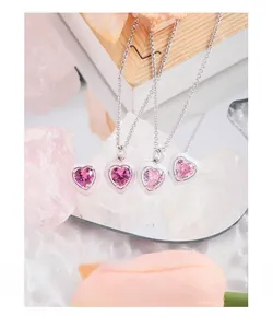 Macro shot of pink heart-shaped crystal pendant necklace with refined enamel edging