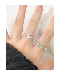 Detail of S925 silver rings with pearl and gear zircon in mixed metal finish