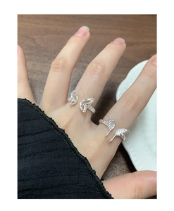 Close-up of S925 silver butterfly and wing rings with unique wrinkled texture