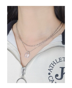 Detail of silver double layer necklace featuring a transparent square crystal pendant