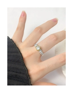 Macro view of S925 silver gear ring with gold-plated bezel and sparkling round zircon