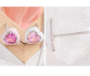Detailed macro view of S925 silver heart studs with pink zircon and enamel finish