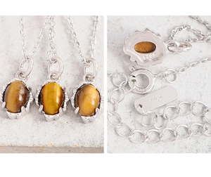 Macro shot of S925 sterling silver hallmarked clasp and oval tiger eye stone pendant detail