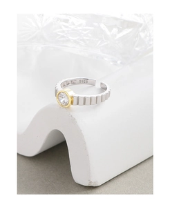 Detailed view of S925 silver gear ring with gold-plated zircon inlay on white wave stand