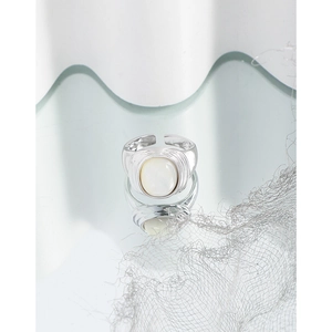 Minimalist S925 sterling silver ring with oval white mother of pearl on a mirror surface