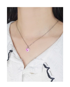 Close-up of pink heart-shaped zircon pendant with silver S925 chain on neck