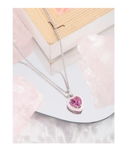 Detail of S925 silver necklace with pink enamel heart pendant and zircon gemstone