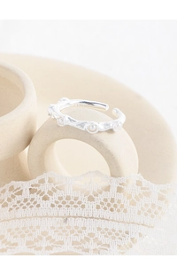 Close-up of S925 sterling silver ring with wrinkled texture and tiny pearls inlay